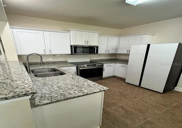 Photo 2 of Townhouse for sale at 6058 Twain St #101, Orlando, FL 32835 | MLS# O6415953 | Listing updated on 2026-09-14