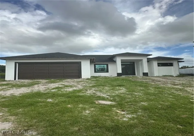 Photo 1 of Single family home for sale at 703 Coolidge Ave, Lehigh Acres, FL 33936 | MLS# 225016403 | Listing updated on 2025-12-30