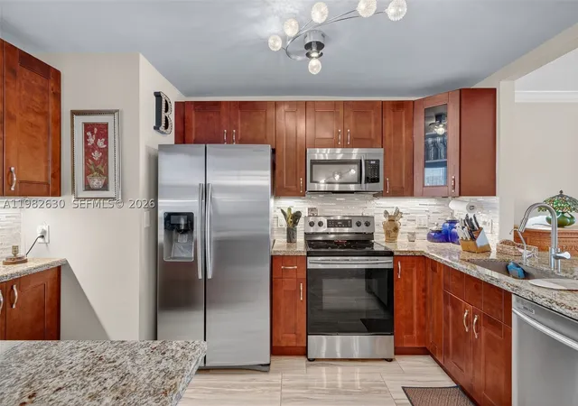Listing Photo 1 - Condo for sale in building located at 121 Golden Isles Dr, Hallandale Beach, FL 33009 - Unit #205