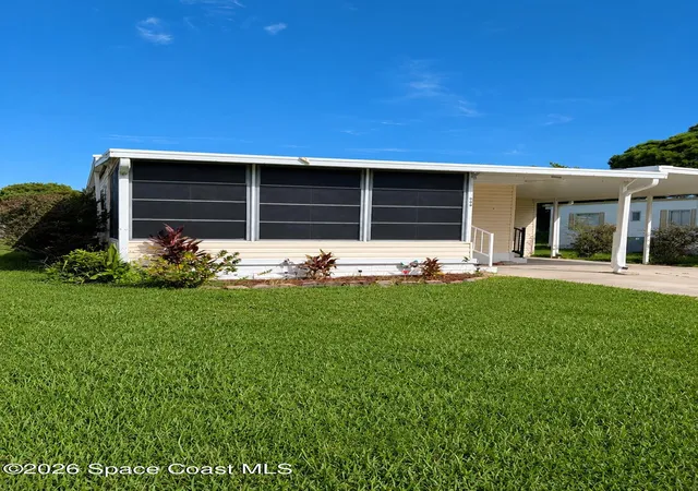 Photo 1 of Manufactured home for sale at 1009 Buttonwood St E, Barefoot Bay, FL 32976 | MLS# 1086136 | Listing updated on 2026-09-17