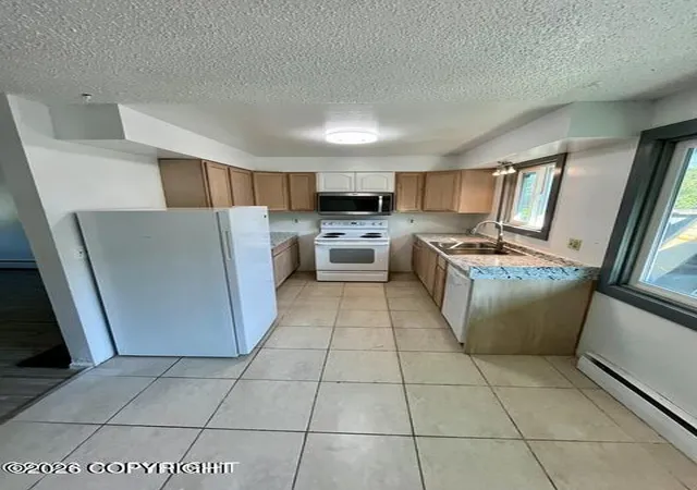 Photo 3 of Multi family home for sale at 4208 Mcphee Ave, Anchorage, AK 99508 | MLS# 26-10913 | Listing updated on 2026-10-07