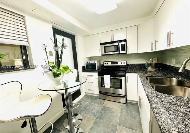 Listing Photo 3 - Condo for sale in building located at 301 Golden Isles Dr, Hallandale Beach, FL 33009 - Unit #114
