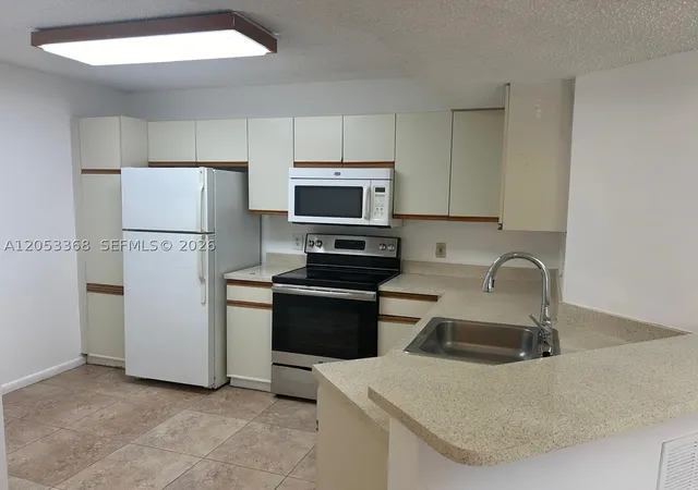Listing Photo 4 - Condo for sale in building located at 8851 Wiles Rd, Coral Springs, FL 33067 - Unit #208