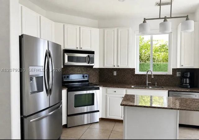 Photo 4 of Townhouse for sale at 11520 NW 79th Lane, Doral, FL 33178 | MLS# A12079210 | Listing updated on 2026-09-16
