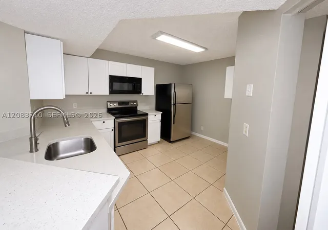 Photo 2 of Condo for sale at 8821 Wiles Rd #102, Coral Springs, FL 33067 | MLS# A12083710 | Listing updated on 2026-09-13