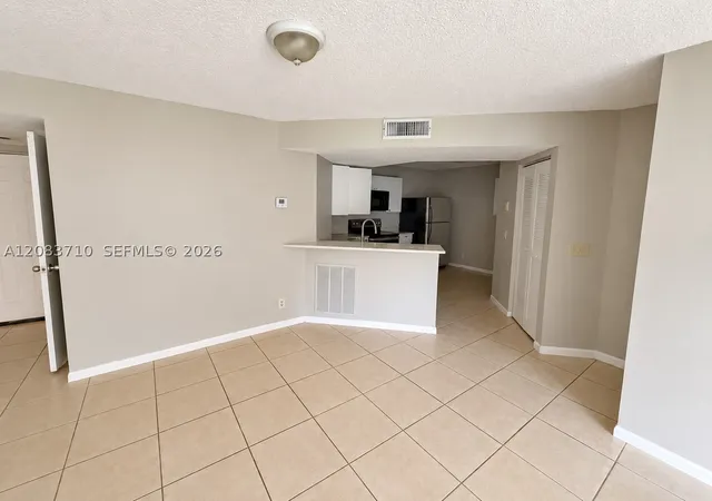Photo 3 of Condo for sale at 8821 Wiles Rd #102, Coral Springs, FL 33067 | MLS# A12083710 | Listing updated on 2026-09-13